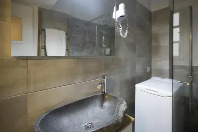 a bathroom with a large sink and a toilet at Apollonos Studio Amalia in Athens