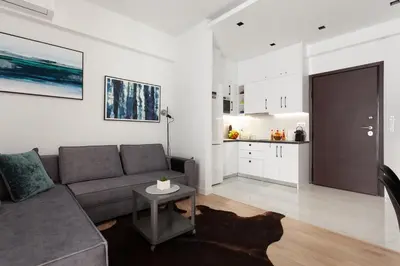 a living room with a couch and a table at Modern Comfort in the Heart of Athens in Athens