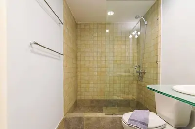a bathroom with a shower with a toilet and a sink at Unique Apartment near Acropolis in Athens