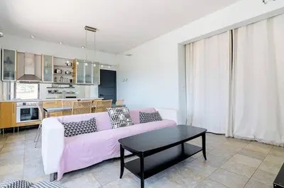 a living room with a pink couch and a table at Unique Apartment near Acropolis in Athens