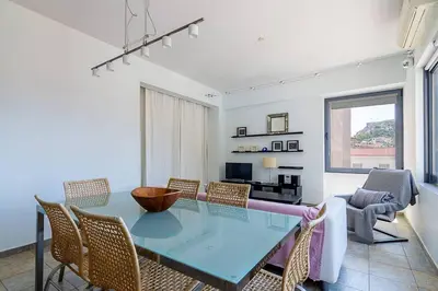 a dining room with a glass table and chairs at Unique Apartment near Acropolis in Athens