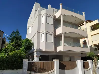 a white building with a fence in front of it at Alimos Luxury Prestige in Athens