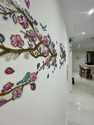a wall mural of a tree with birds and flowers at Alimos Luxury Prestige in Athens