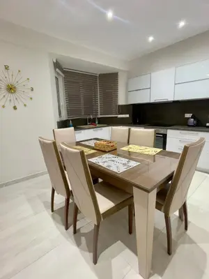 a kitchen with a dining room table and chairs at Alimos Luxury Prestige in Athens