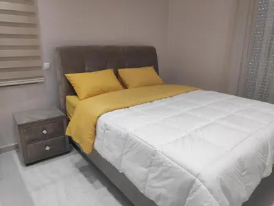 a bedroom with a bed and a night stand at Alimos Luxury Prestige in Athens