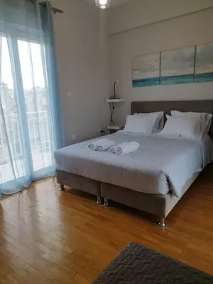 a bedroom with a large bed with white pillows at EL GRECO Penthouse in Vibrant Petralona in Athens