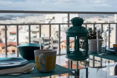 a green lantern sitting on a table on a balcony at EL GRECO Penthouse in Vibrant Petralona in Athens
