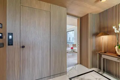 a hallway with a wooden door in a house at The One Acropolis in Athens