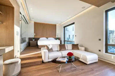a living room with a couch and a bed at The One Acropolis in Athens