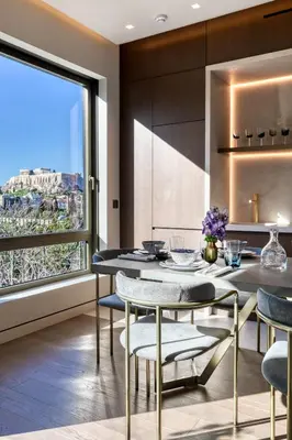 a kitchen with a table and chairs and a large window at The One Acropolis in Athens