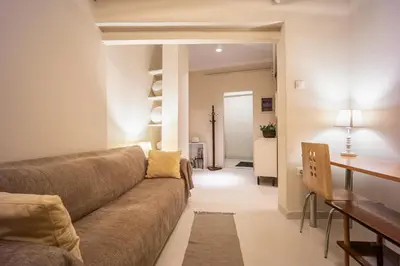 a living room with a couch and a table at Zacharitsa APT at Acropolis up 4 guests by LODGESPOT in Athens