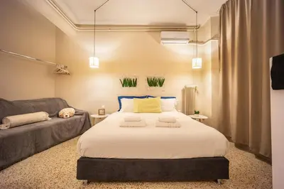a bedroom with a large bed and a couch at Zacharitsa APT at Acropolis up 4 guests by LODGESPOT in Athens