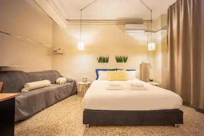 a bedroom with a large bed and a couch at Zacharitsa APT at Acropolis up 4 guests by LODGESPOT in Athens