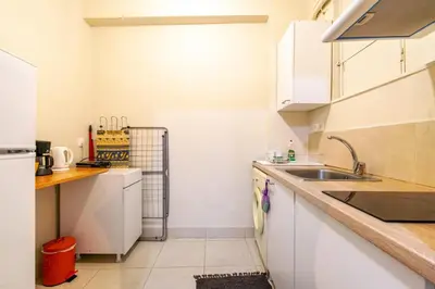 a kitchen with white cabinets and a sink at Zacharitsa APT at Acropolis up 4 guests by LODGESPOT in Athens