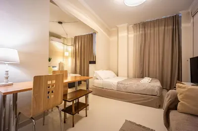 a hotel room with a bed and a desk and a bed at Zacharitsa APT at Acropolis up 4 guests by LODGESPOT in Athens