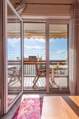 a room with a view of the ocean from a balcony at Sea view apartment 100m from the beach in Saronida