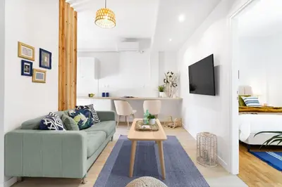 a living room with a couch and a bed at Modern & Stylish Hideaway Downtown near Acropolis & Metro in Athens