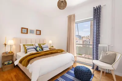 a bedroom with a bed and a window and a chair at Modern & Stylish Hideaway Downtown near Acropolis & Metro in Athens
