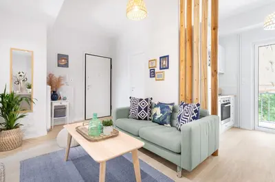 a living room with a green couch and a table at Modern & Stylish Hideaway Downtown near Acropolis & Metro in Athens