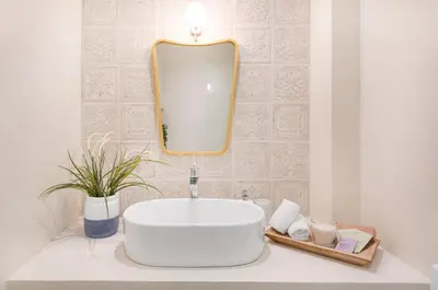 a bathroom with a white sink and a mirror at Modern & Stylish Hideaway Downtown near Acropolis & Metro in Athens