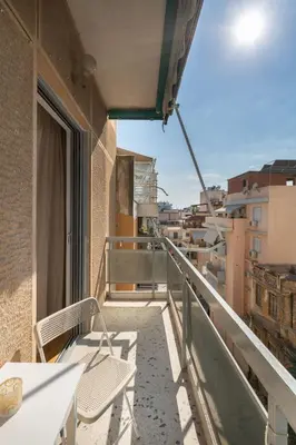a balcony with chairs and a view of a city at Modern & Stylish Hideaway Downtown near Acropolis & Metro in Athens