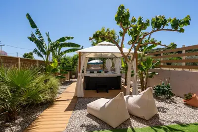 a gazebo with a table in a garden at Modular Bungalows With Heated Pool Artemis Greece in Artemida