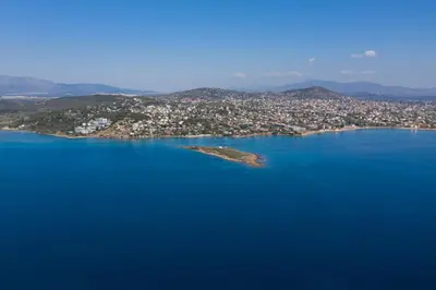 an island in the middle of a large body of water at Modular Bungalows With Heated Pool Artemis Greece in Artemida