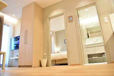 a room with a bed and a large mirror at Mood Athens Luxury Apartments and Suites in Athens