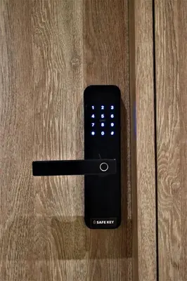 a remote control sitting on top of a wooden table at Mood Athens Luxury Apartments and Suites in Athens