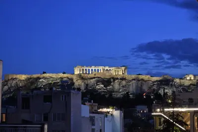 a view of the acropolis of athens at night at Mood Athens Luxury Apartments and Suites in Athens