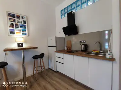 a small kitchen with a sink and a refrigerator at Studio in Kallithea next to Kiprou square in Athens