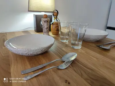 a table with a bowl and a fork and glasses at Studio in Kallithea next to Kiprou square in Athens