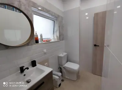 a bathroom with a sink and a toilet and a mirror at Studio in Kallithea next to Kiprou square in Athens