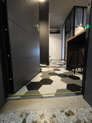 a hallway with a black and white checkered floor and a piano at WYN Comfort Studio in Kallithea Near SNFCC and Seasi in Athens