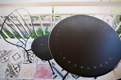 two black chairs sitting on a balcony at WYN Comfort Studio in Kallithea Near SNFCC and Seasi in Athens
