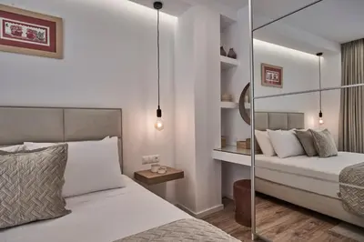 a bedroom with two beds and a glass wall at Charitos Boutique Apartment, Kolonaki in Athens