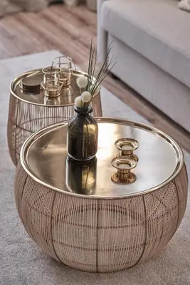 a metal coffee table with a vase on top of it at Charitos Boutique Apartment, Kolonaki in Athens