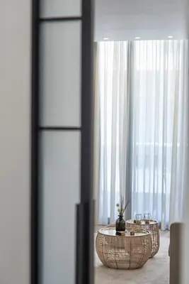 a room with two tables in front of a window at Charitos Boutique Apartment, Kolonaki in Athens