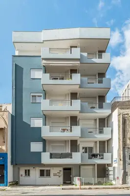 an apartment building with balconies on the side of it at Elvita Apartments 3 in Athens
