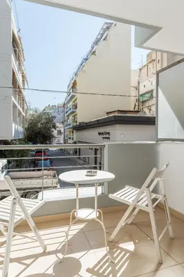 a white table and two chairs on a balcony at Elvita Apartments 3 in Athens