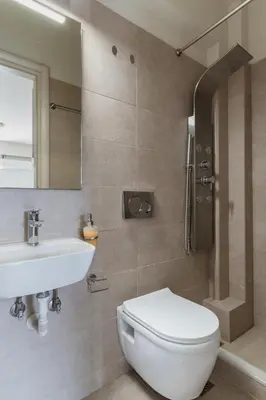 a bathroom with a toilet and a sink and a shower at Elvita Apartments 3 in Athens