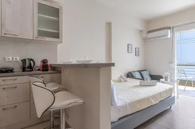 a small bedroom with a bed and a kitchen at Elvita Apartments 3 in Athens