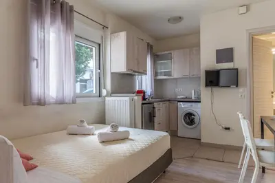 a bedroom with a bed with towels on it at Elvita Apartments 3 in Athens