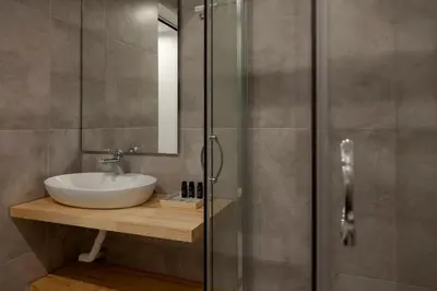 a bathroom with a sink and a glass shower at STAY INN in Athens