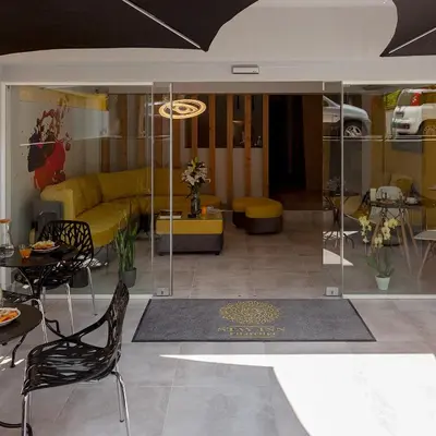 a living room with a yellow couch and a table and chairs at STAY INN in Athens