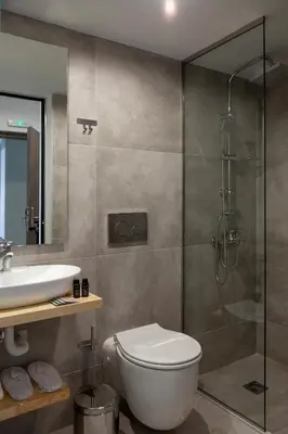 a bathroom with a toilet and a sink and a shower at STAY INN in Athens