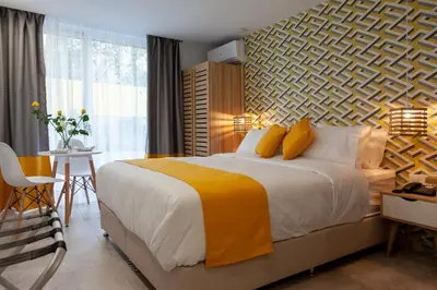 a bedroom with a large bed and a table and chairs at STAY INN in Athens