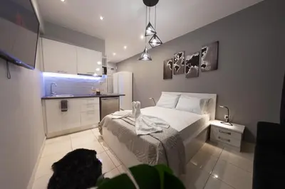 a small bedroom with a bed and a kitchen at AcroView Right In The Center in Athens