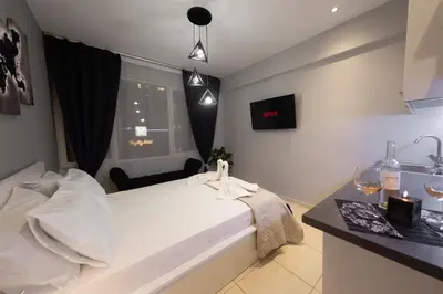 a bedroom with a white bed and a window at AcroView Right In The Center in Athens
