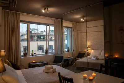 a hotel room with two beds and a large window at AcroView Right In The Center in Athens